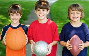 Three Boys Holding Sports Balls