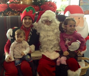 Denise the Christmas Elf with Santa and two kids