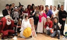 Costumed employees posing during a company Halloween party, including the creative Miss Bacon-and-Egg