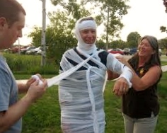 Smiling employees playing the Mummy Wrap game