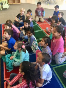 Children look intently during Denise's Magic Comedy Show at a preschool birthday party.