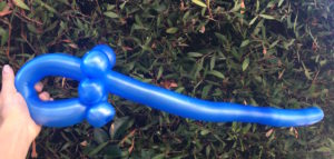 a blue balloon twisted into the shape of a sword