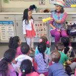 Denise interacts with the kids during her Magic Comedy Show at a preschool birthday party.